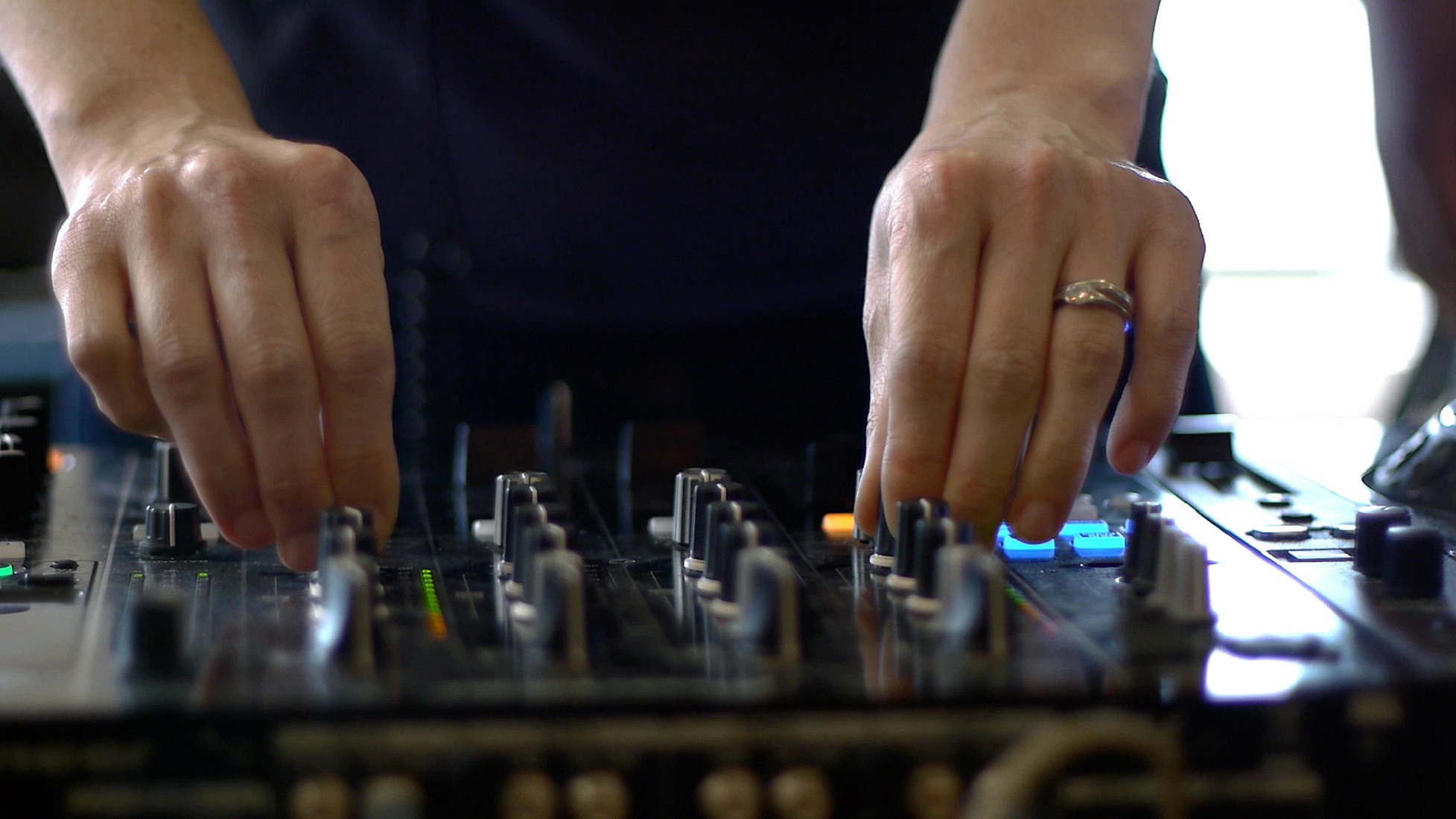 A woman's hands using mixing equipment