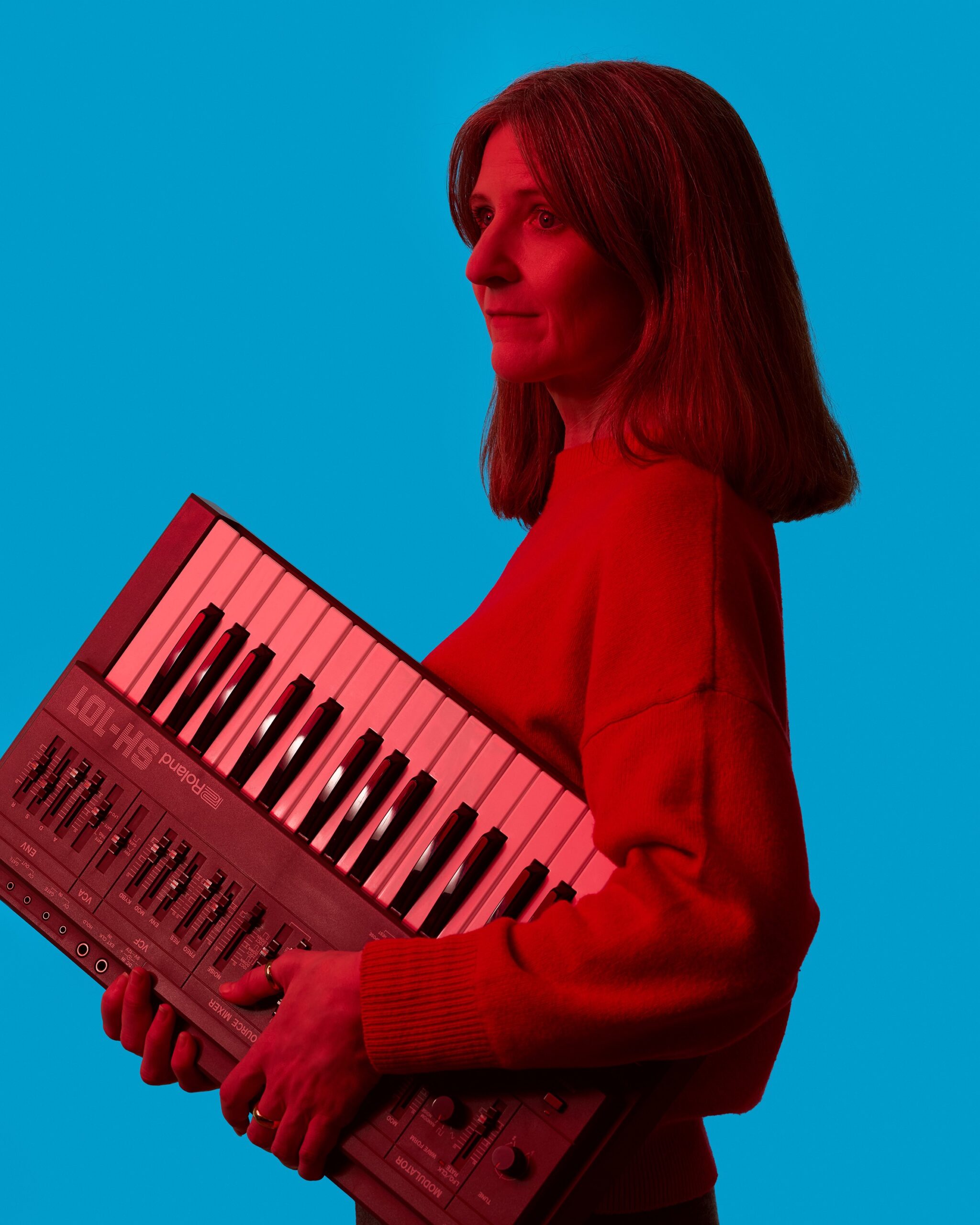 Naomi Hart holding an SH-101 synth